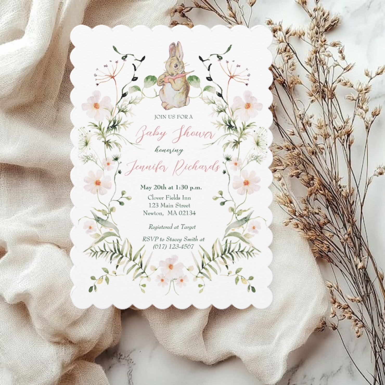 This baby shower invitation features delicate hand painted wildflowers including white daisies with a yellow center along with a vintage baby bunny eating a carrot by Beatrix Potter